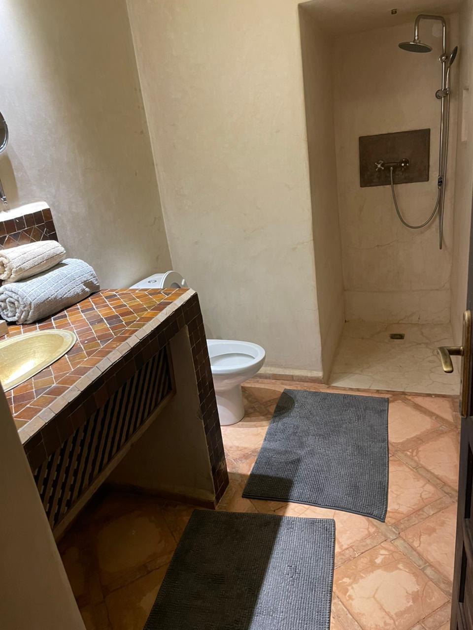 Spacious bathroom with modern amenities and Moroccan touches